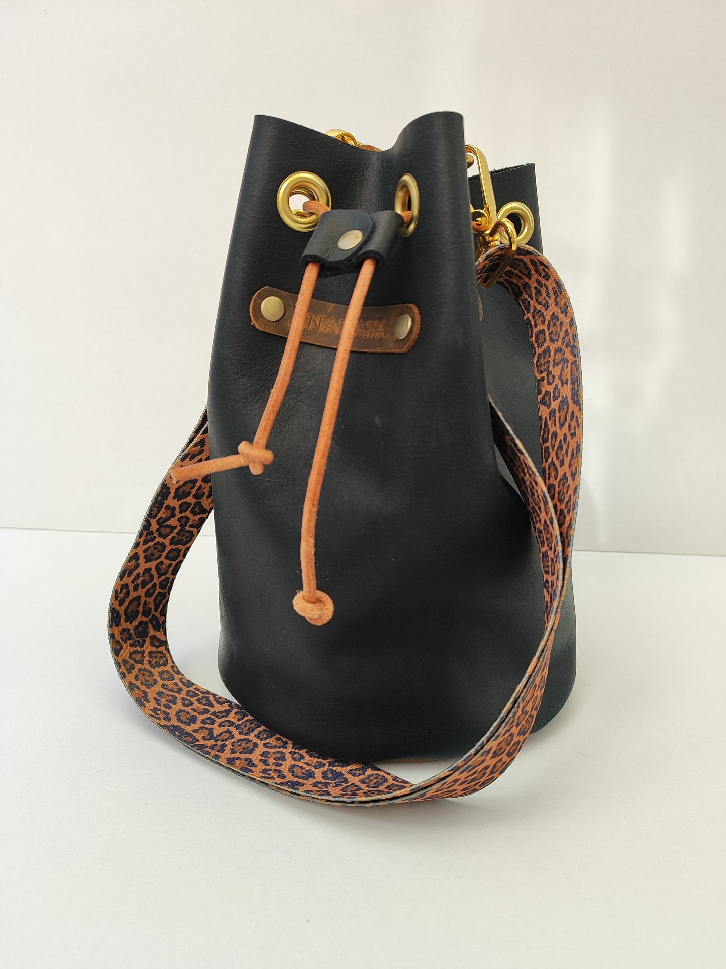 Χειροποίητη δερμάτινη τσάντα πουγκί - μαύρο με καφέ και χρυσές λεπτομέρειες και λεοπάρ ιμάντα.